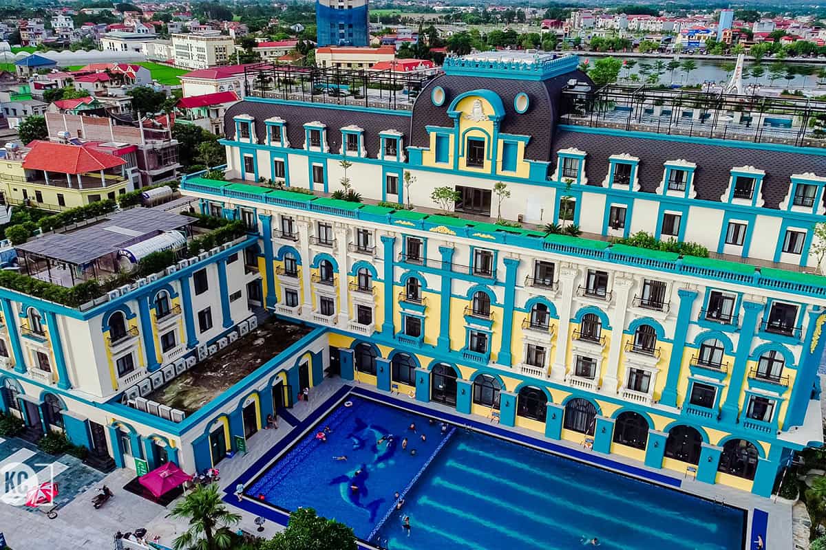 Aerial view of Thien An Hotel in Viet Yen with pool and colorful facade
